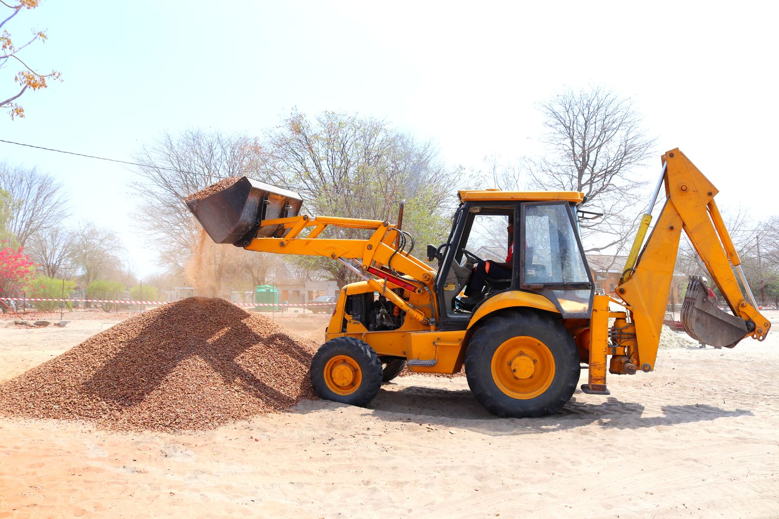 Loader moving stone on site